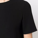 Close up of black dress, showing texture of the triacetate fabric