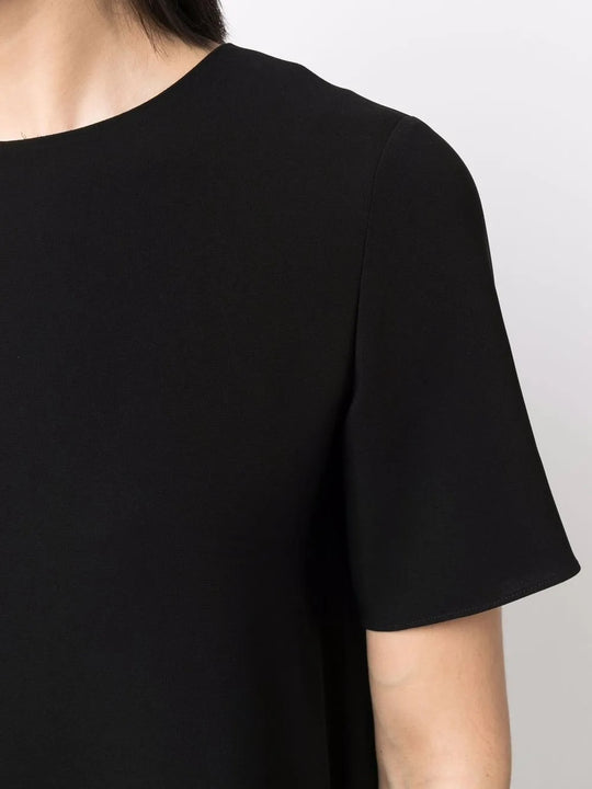 Close up of black dress, showing texture of the triacetate fabric