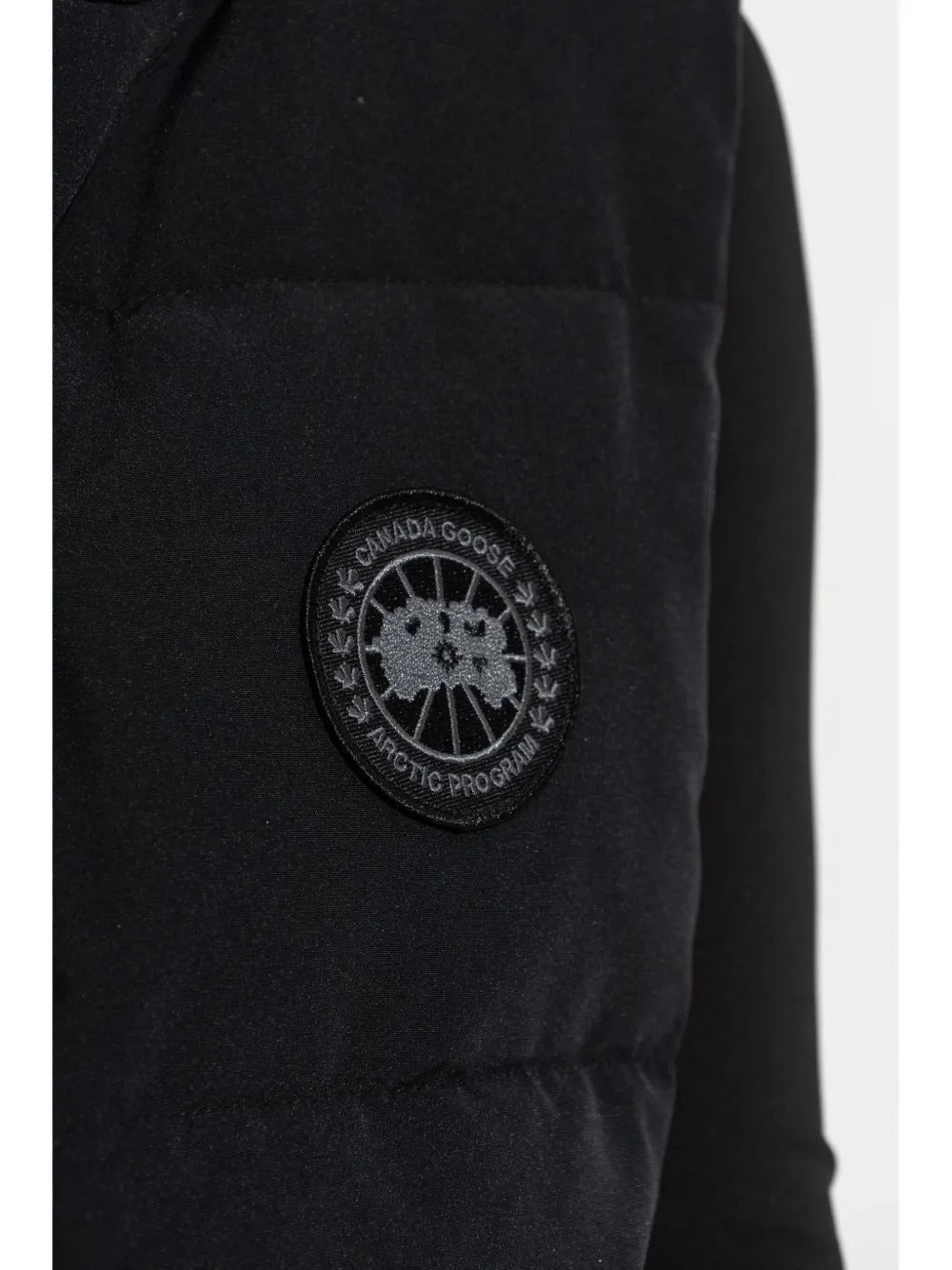 Close up of the black vest, showing texture of the polyester fabric