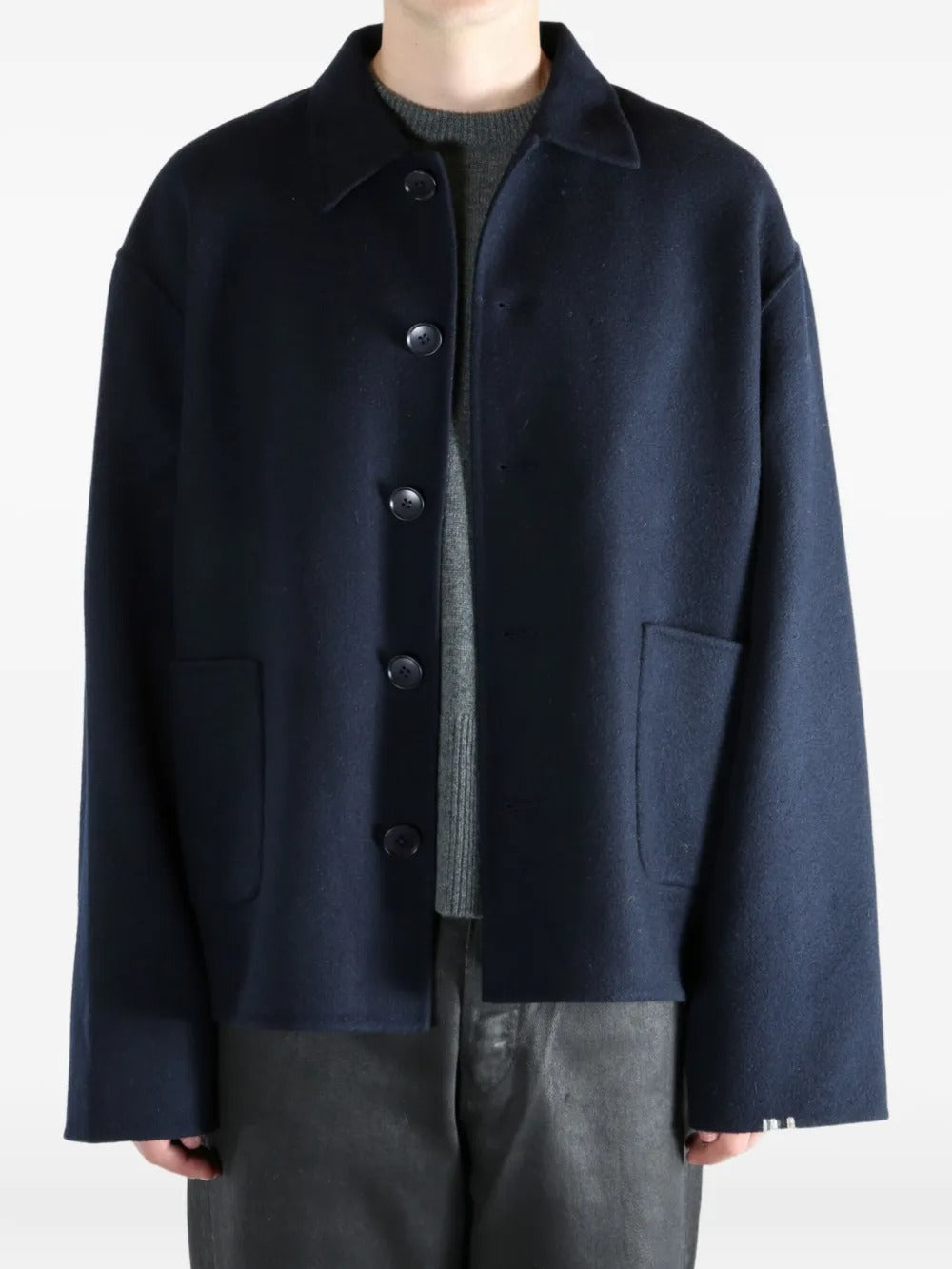 Navy coat worn by a person, showing the coat's fit