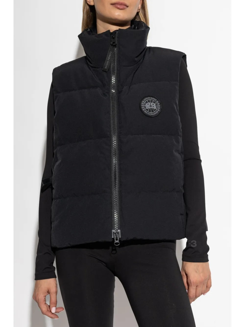 Black vest worn by a person, showing the vest's fit