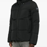 Black coat worn by a person, showing the coat's fit