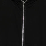 Close up of black hoodie, showing texture of the cotton fabric
