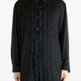 Black coat worn by a person, showing the coat's fit