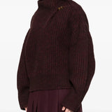 Red sweater worn by a person, showing the sweater's fit