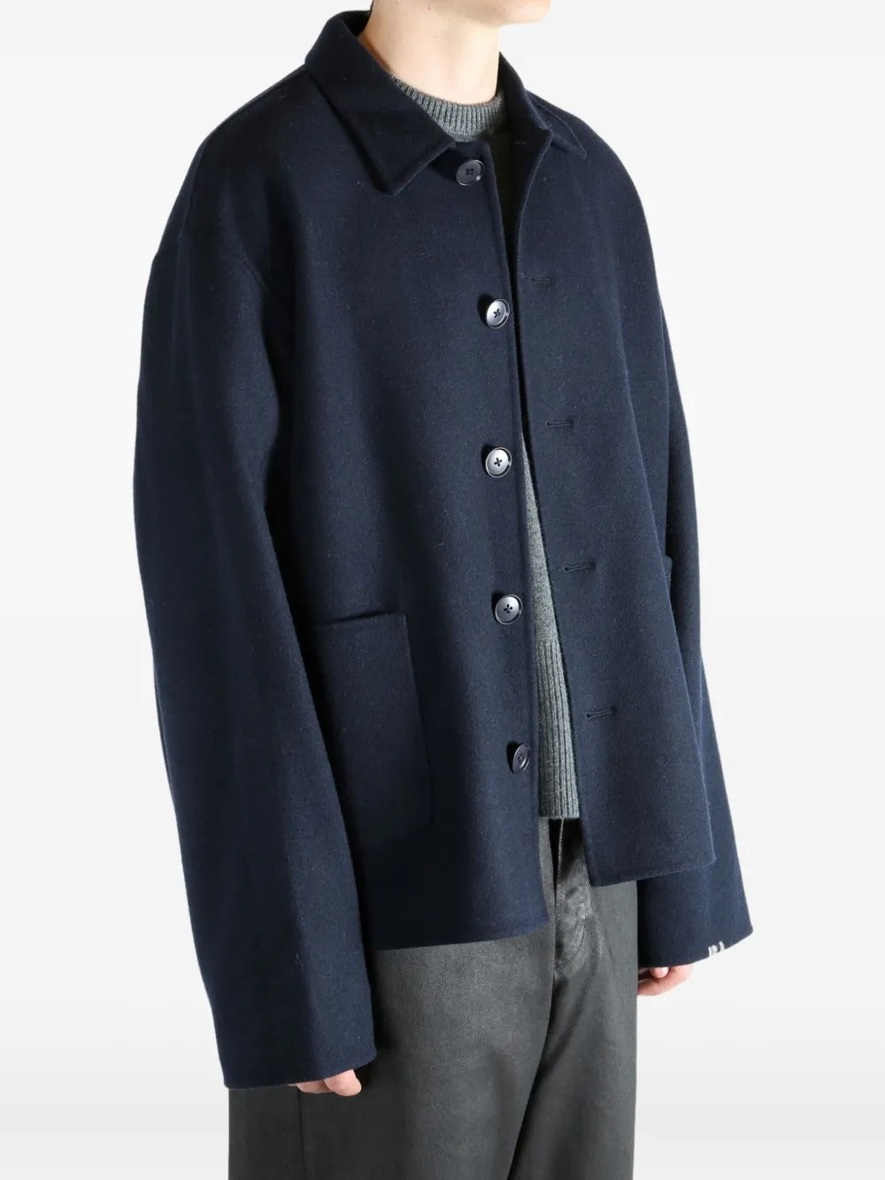 Navy coat worn by a person, showing the coat's fit