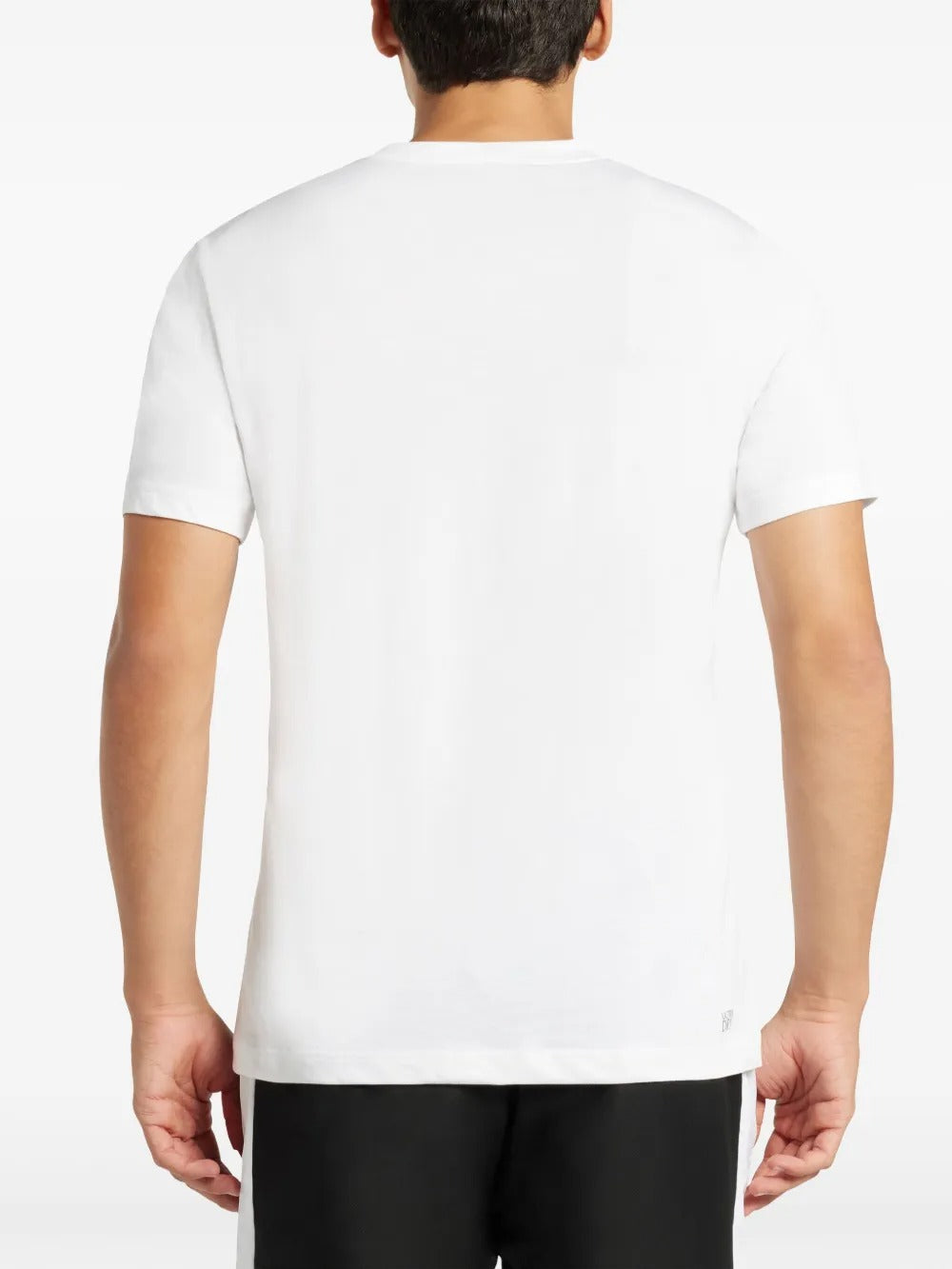 White T-shirt worn by a person, showing the shirt's fit