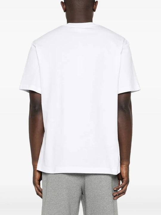 White T-shirt worn by a person, showing the shirt's fit