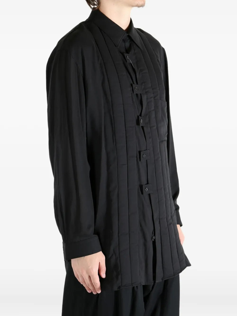 Black coat worn by a person, showing the coat's fit