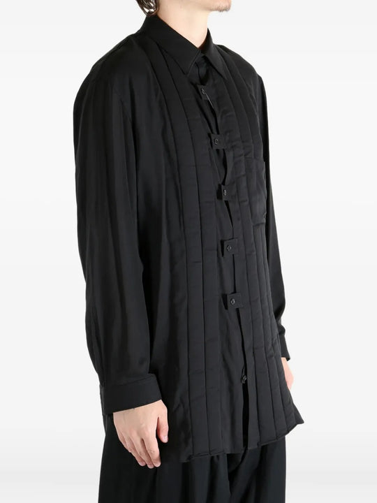 Black coat worn by a person, showing the coat's fit
