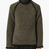 Brown sweater worn by a person, showing the sweater's fit