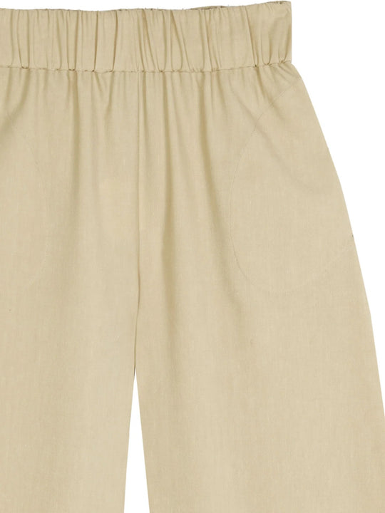 Close up of tan pants, showing texture of the wool fabric