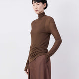 Brown top worn by a person, showing the top's fit