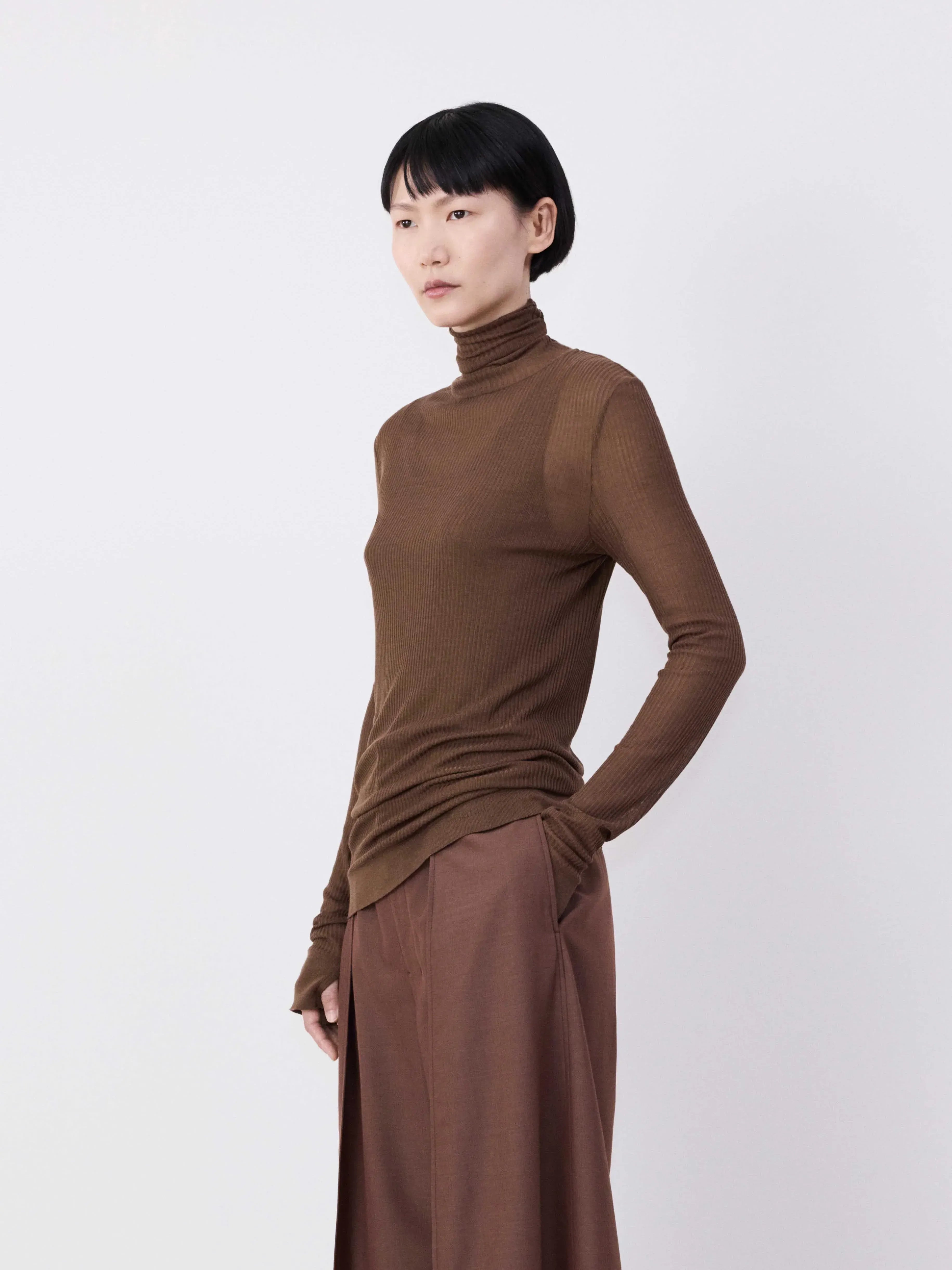Brown top worn by a person, showing the top's fit