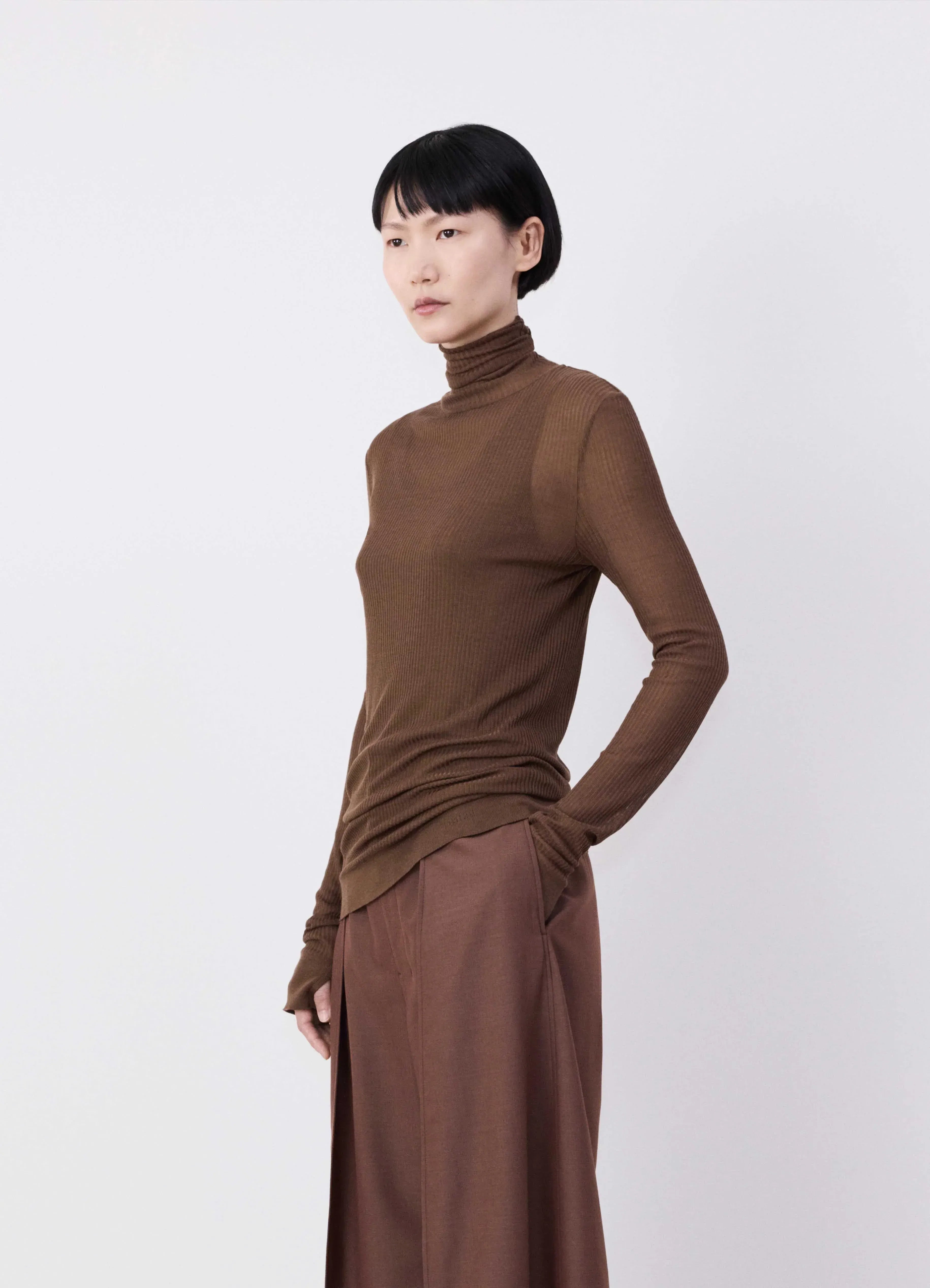 Brown top worn by a person, showing the top's fit