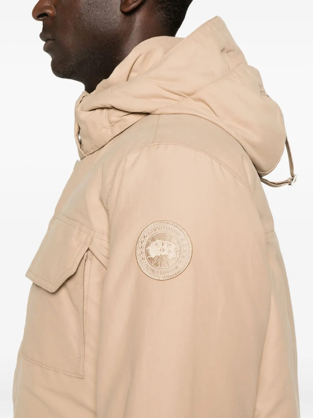 Close up of the tan coat, showing texture of the cotton fabric