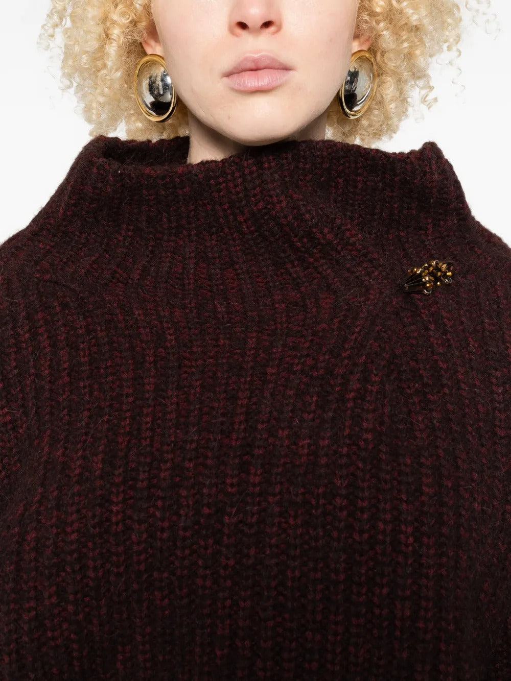 Close up of the red sweater, showing texture of the wool fabric