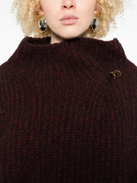 Close up of the red sweater, showing texture of the wool fabric