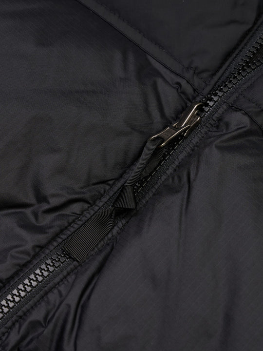 Close up of the black vest, showing texture of the nylon fabric