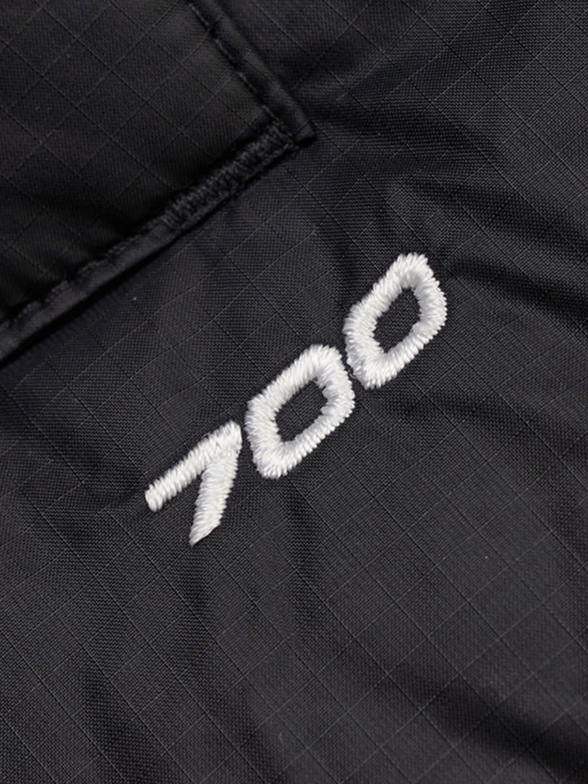 Close up of the black vest, showing texture of the nylon fabric