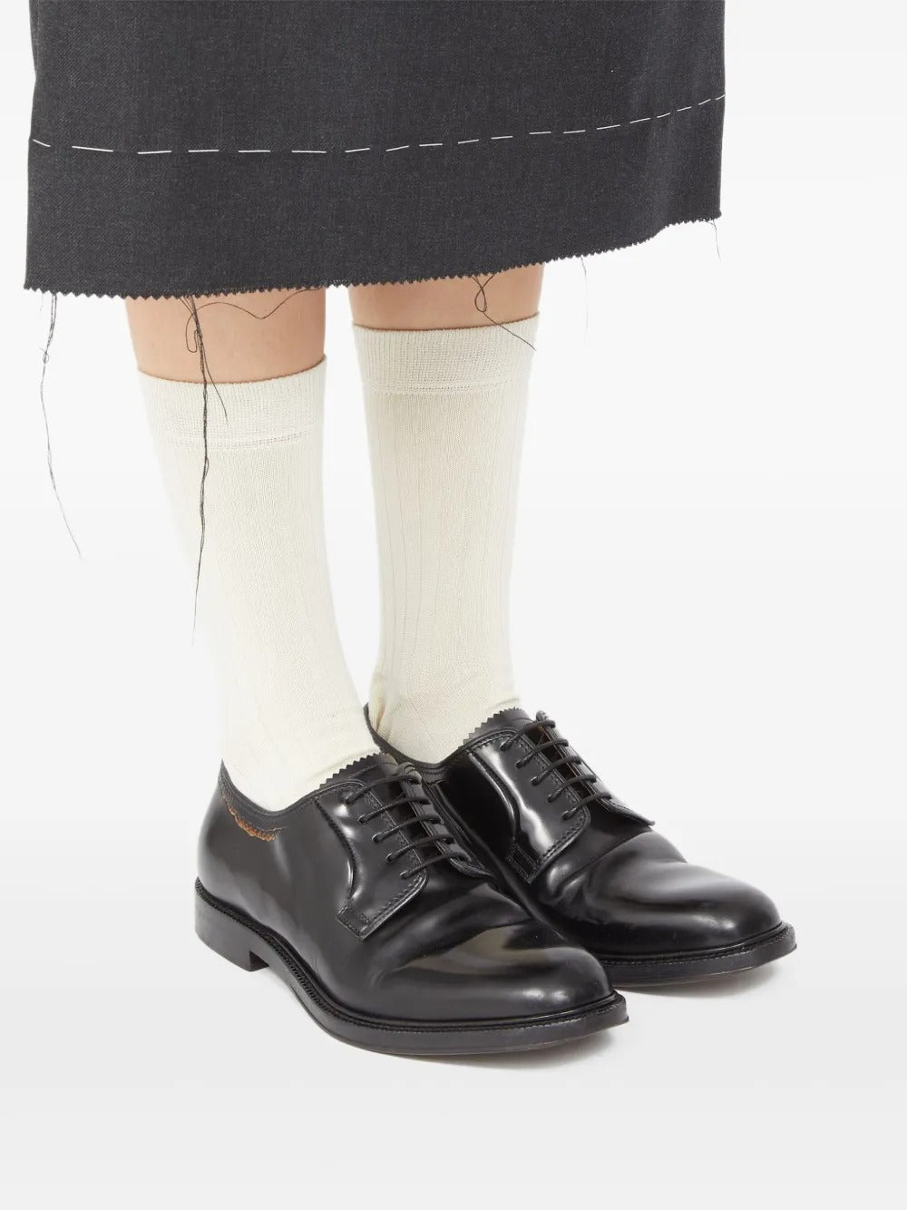 Black shoes worn by a person, showing the shoes' fit