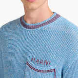 Close up of blue sweater, showing texture of the Cotton fabric