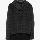 black hoodie worn by a person, showing the hoodie fit