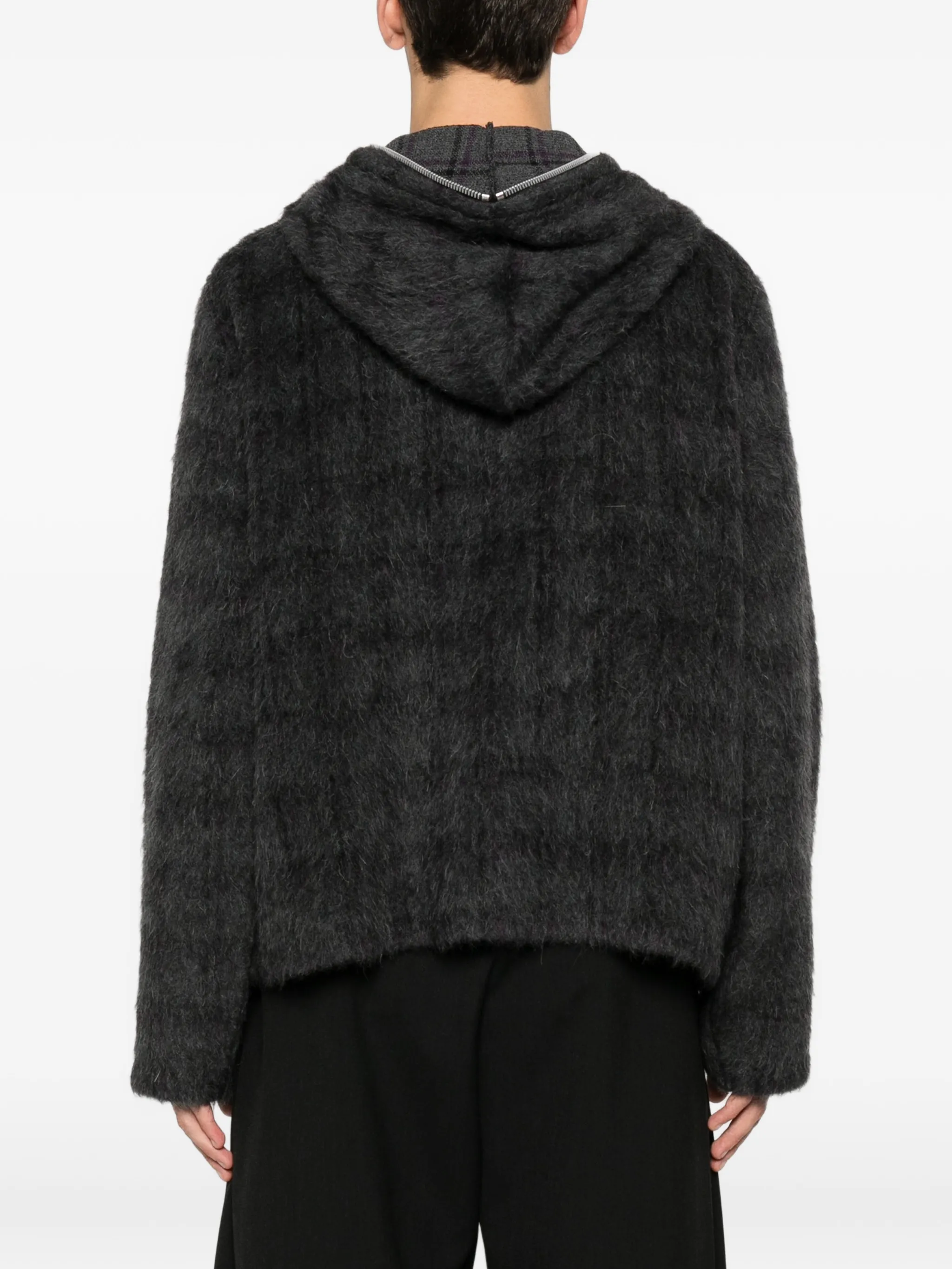 black hoodie worn by a person, showing the hoodie fit