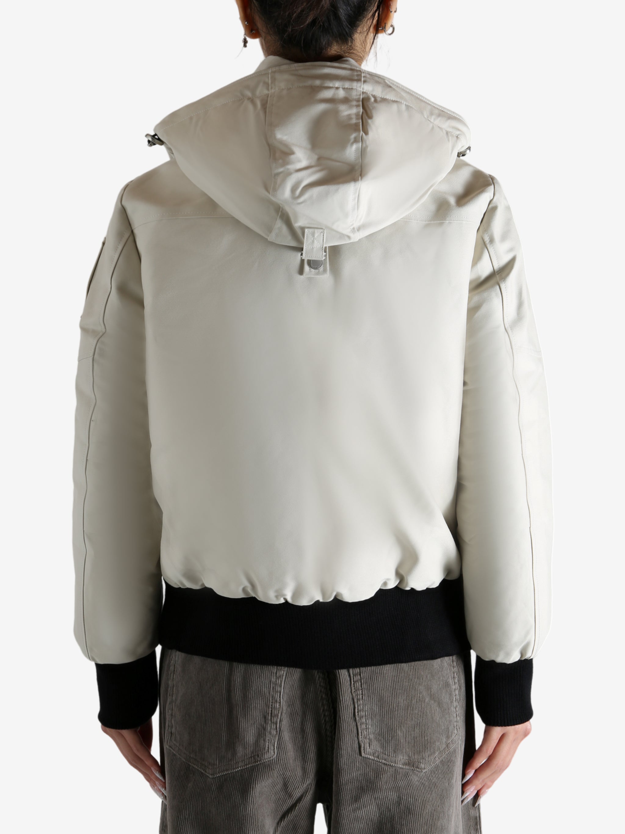 White bomber worn by a person, showing the bomber fit