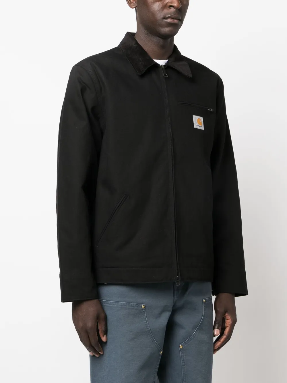 Black jacket worn by a person, showing the jacket fit