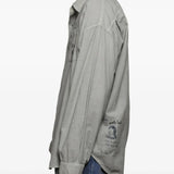 Grey shirts worn by a person, showing the shirts fit