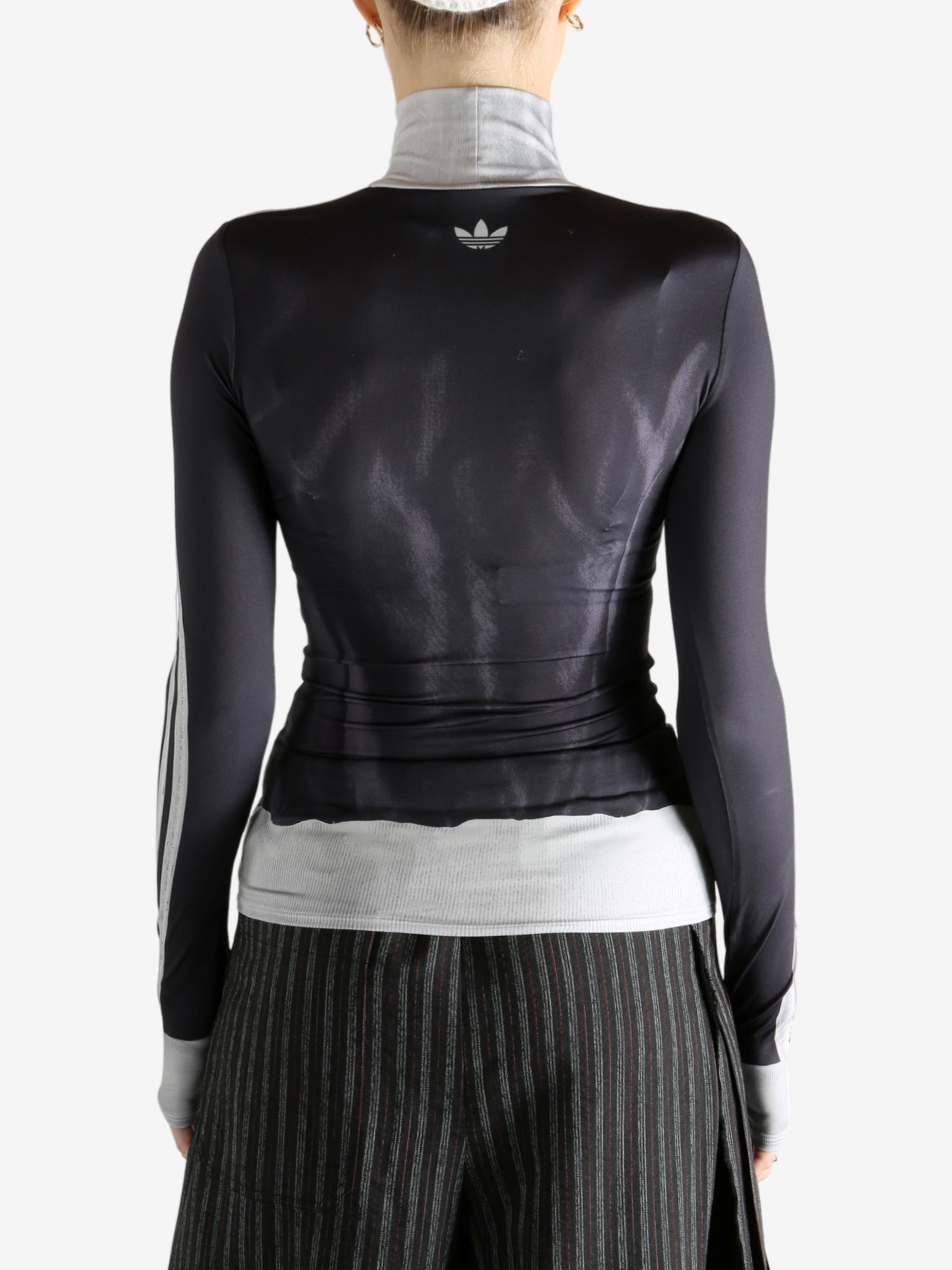 black jacket worn by a person, showing the jacket fit