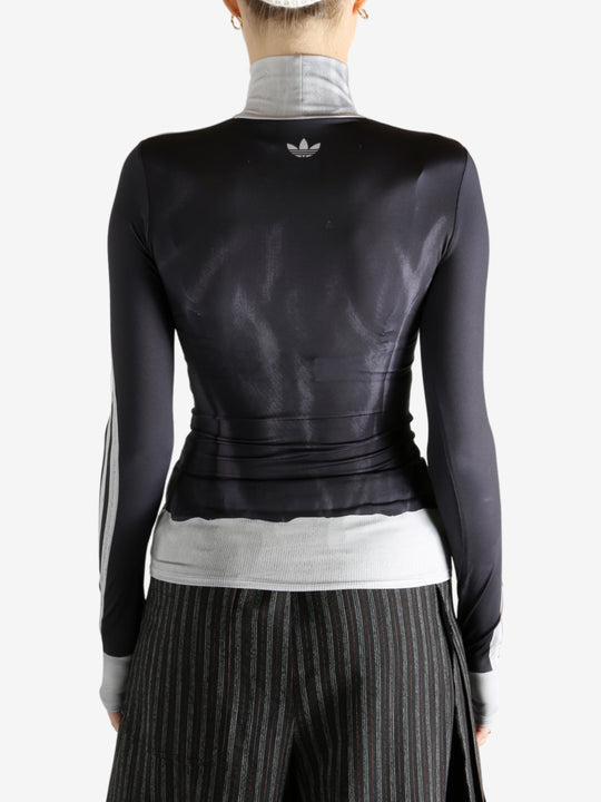 black jacket worn by a person, showing the jacket fit