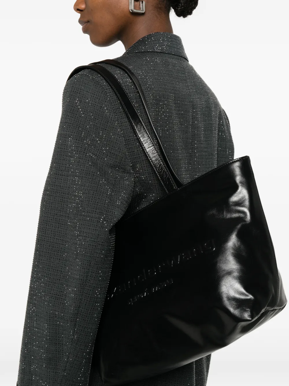 Black handbag worn by a person, showing the handbag fit