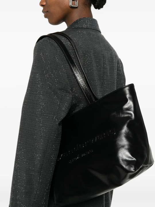 Black handbag worn by a person, showing the handbag fit