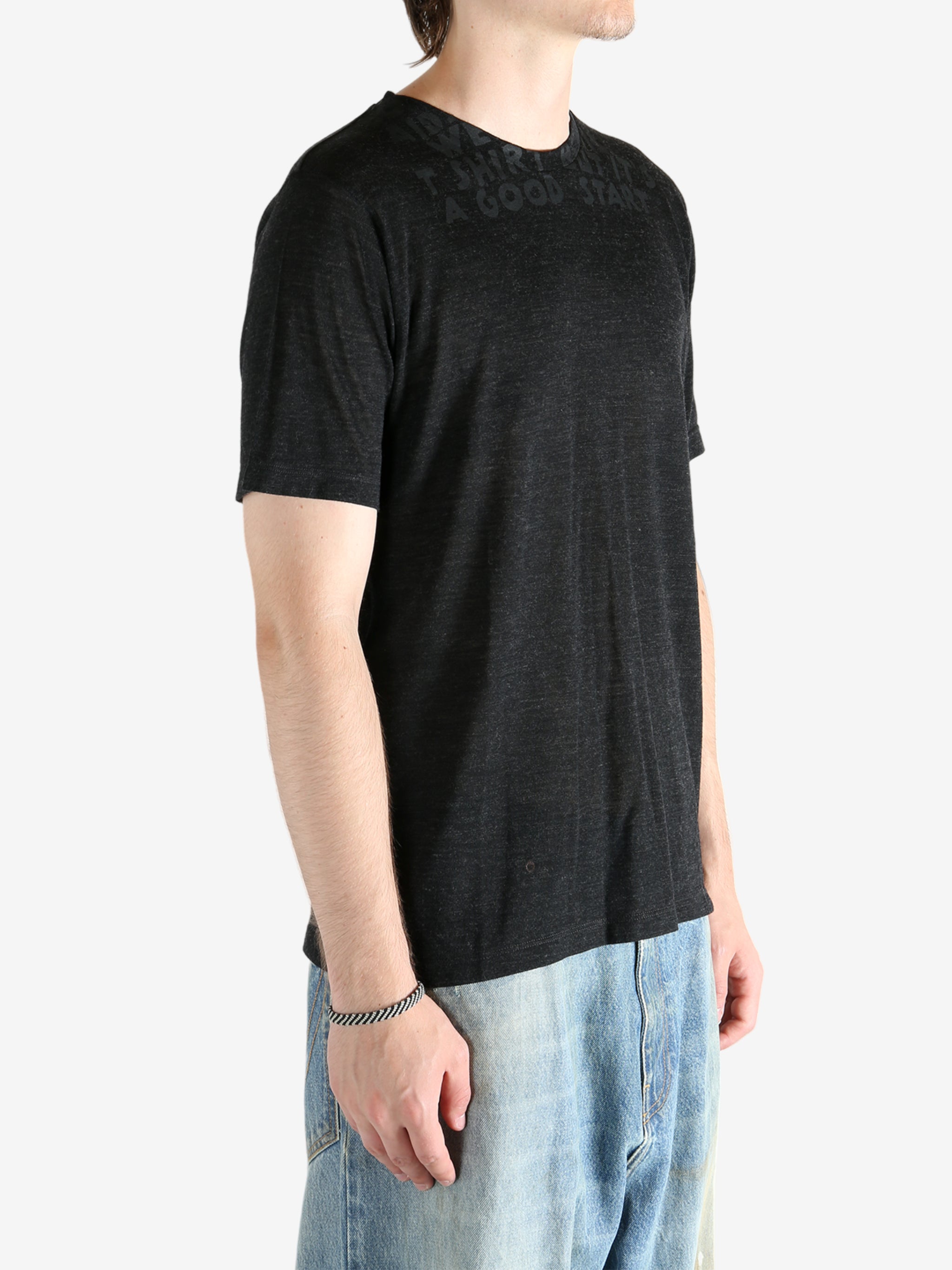 Black shirt worn by a person, showing the shirt fit