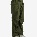 Green pants worn by a person, showing the pant’s fit