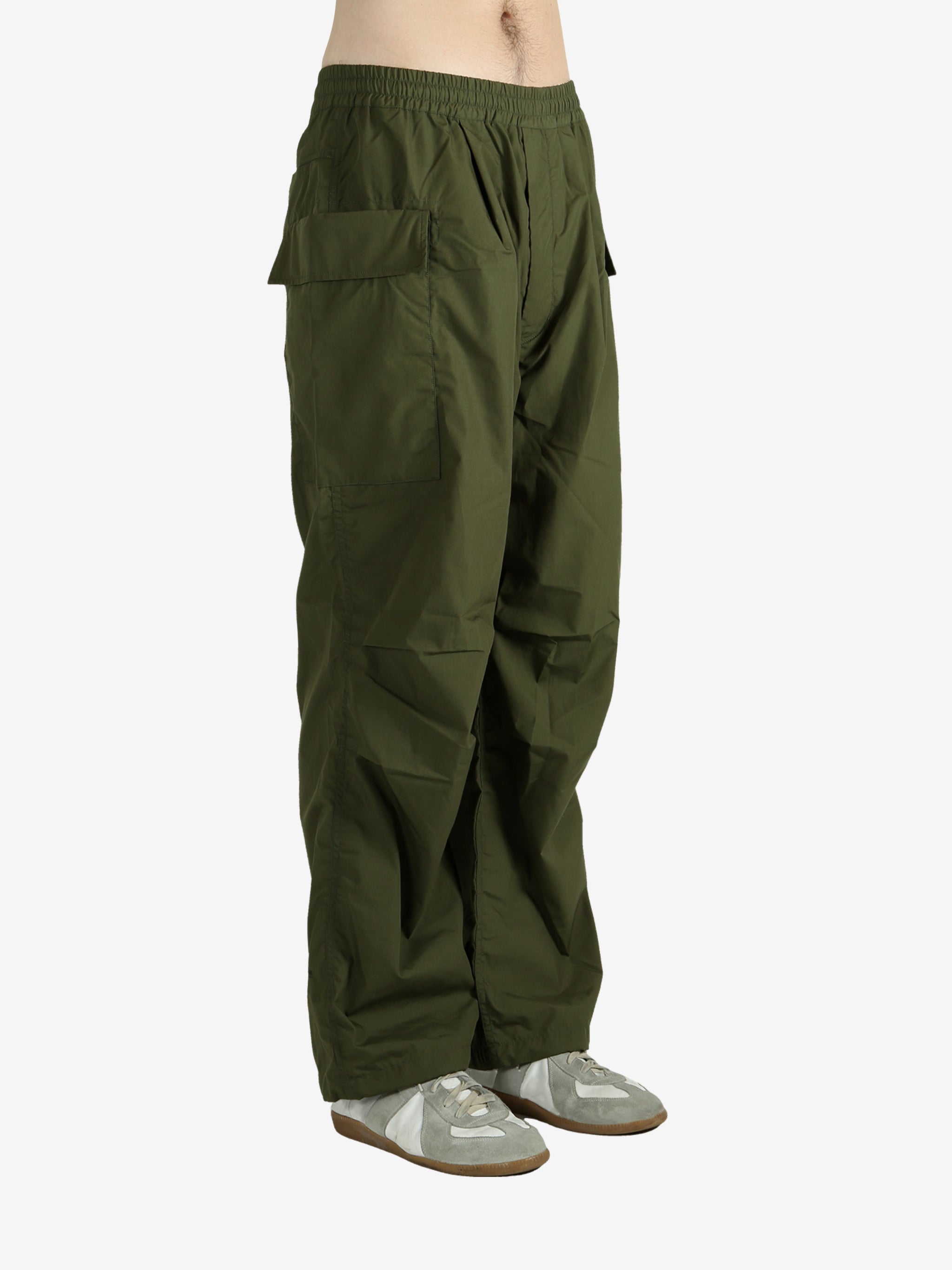 Green pants worn by a person, showing the pant’s fit