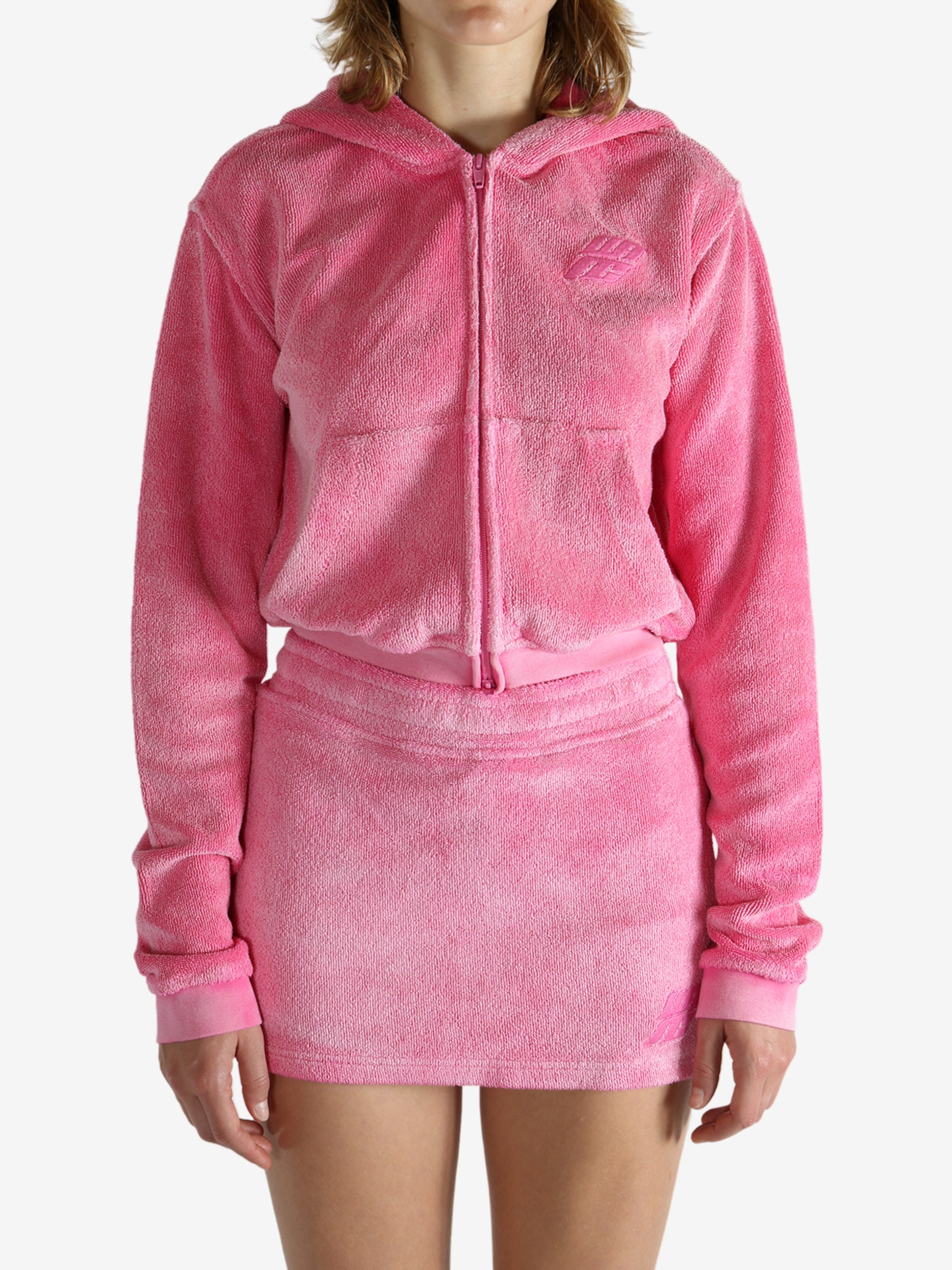Pink hoodie worn by a person, showing the hoodie's fit