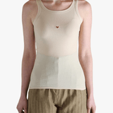 White top worn by a person, showing the top's fit