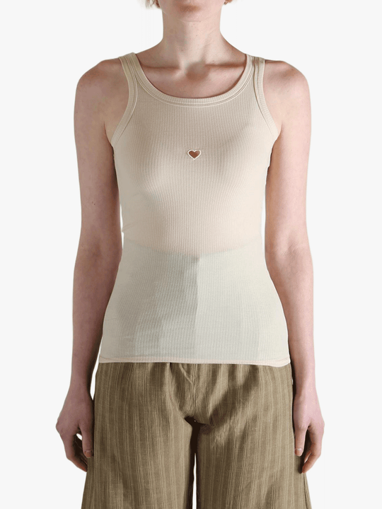 White top worn by a person, showing the top's fit