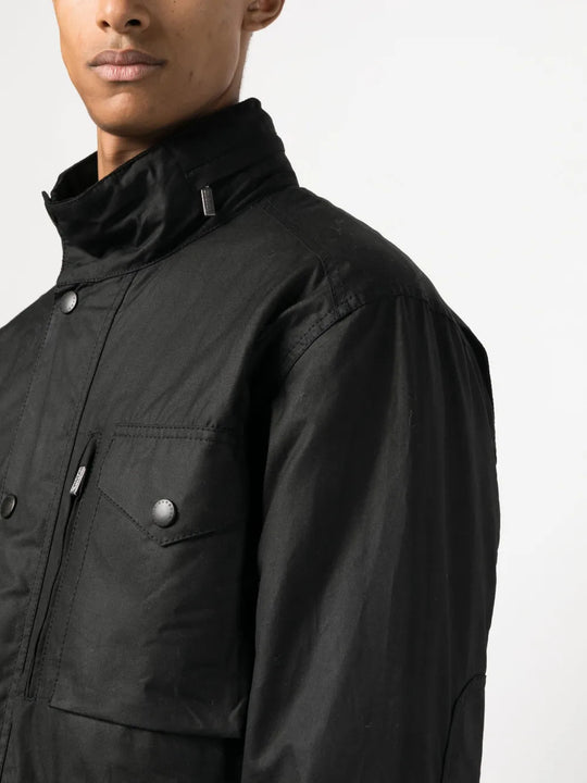 Black jacket worn by a person, showing the jacket fit