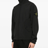 Black jacket worn by a person, showing the jacket fit