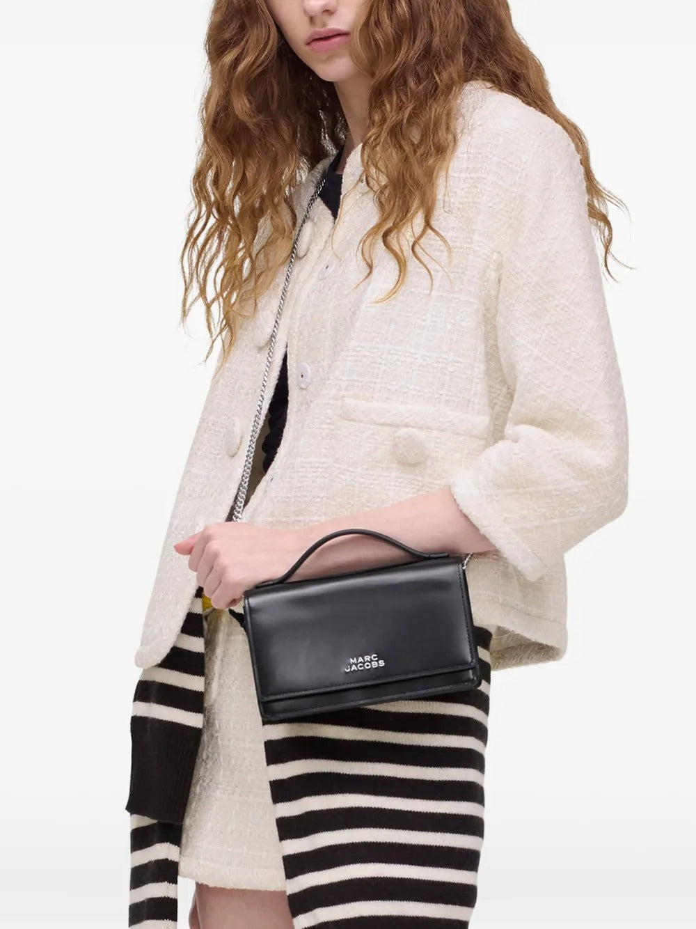 Black bag carried by a person, showing the bag's size