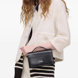 Black bag carried by a person, showing the bag's size