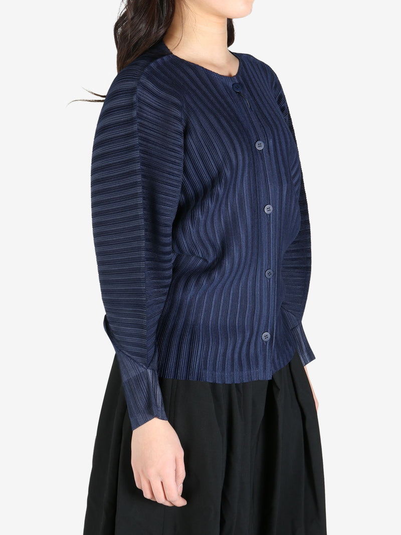 Navy cardigan worn by a person, side view