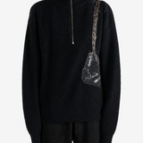 Black knitwear worn by a person, showing the knitwear fit
