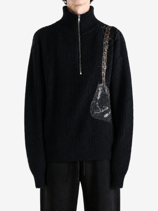 Black knitwear worn by a person, showing the knitwear fit