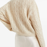 Tan knitwears worn by a person, showing the knitwears fit