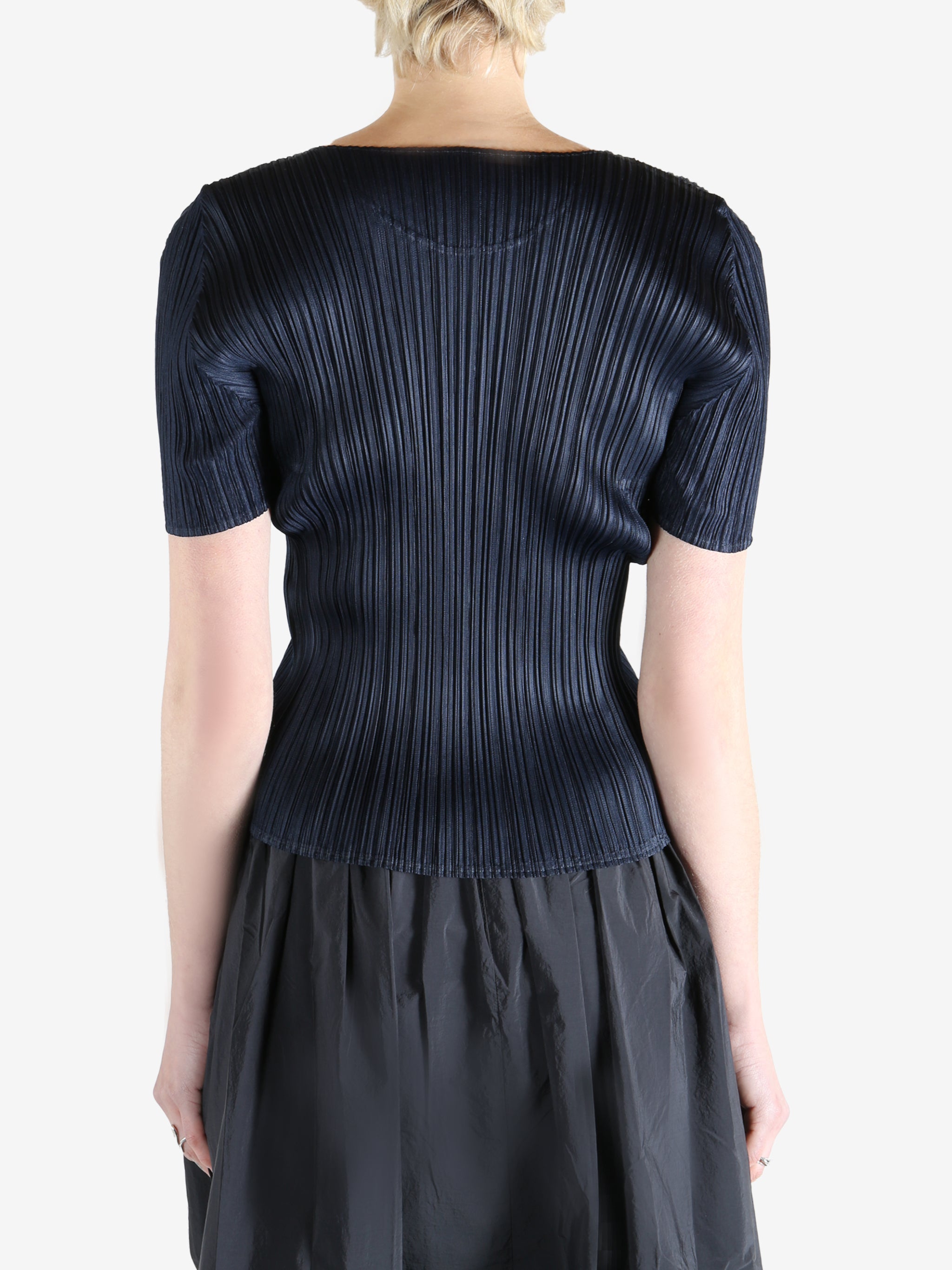 Navy top worn by a person, showing the top's fit